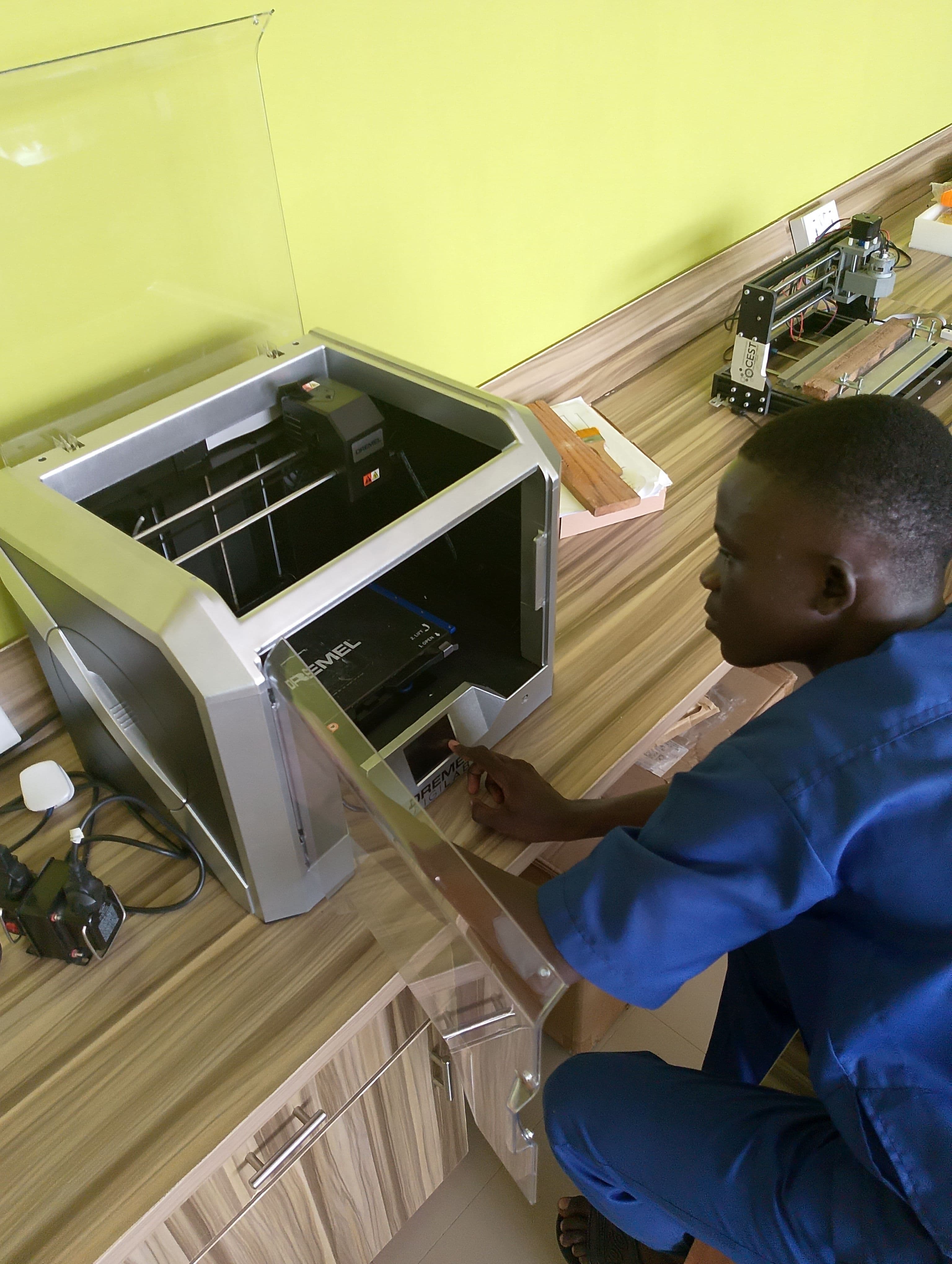 Oladepo Caleb Olugbenga observing a device